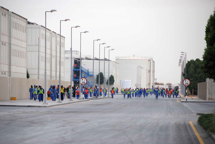 Foreign workers changing shifts at the TDIC construction site, Photo: Hans Haacke/VG Bild-Kunst, Abu Dhabi , June 28, 2010